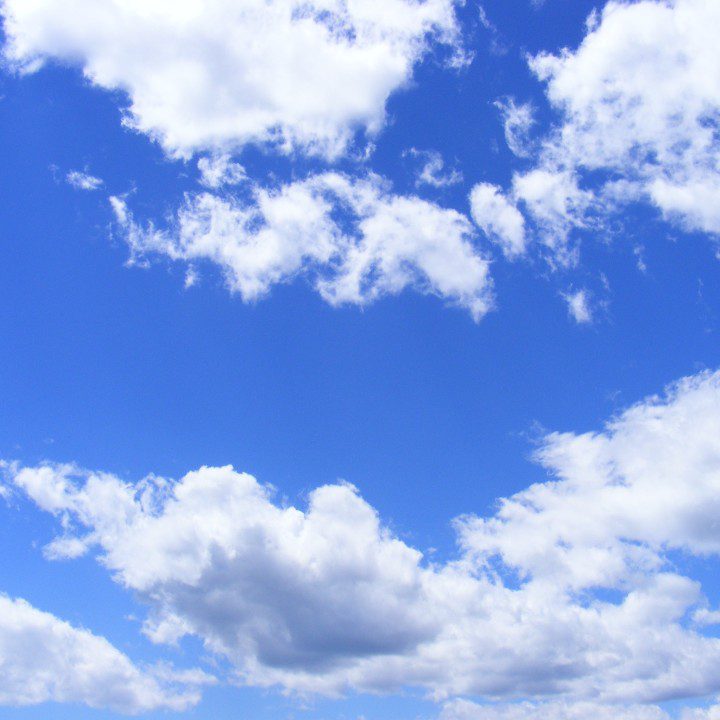 A blue sky with some clouds in the background