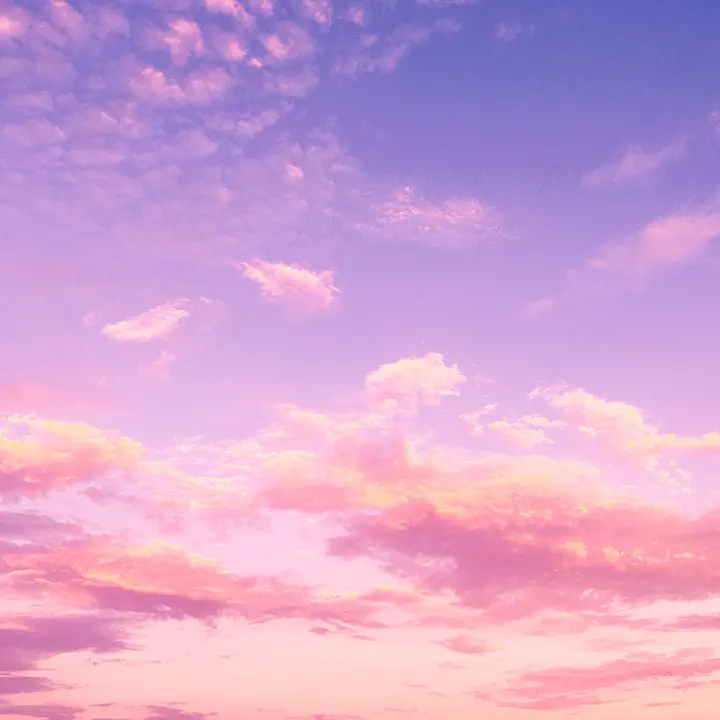 A pink sky with some clouds in the background